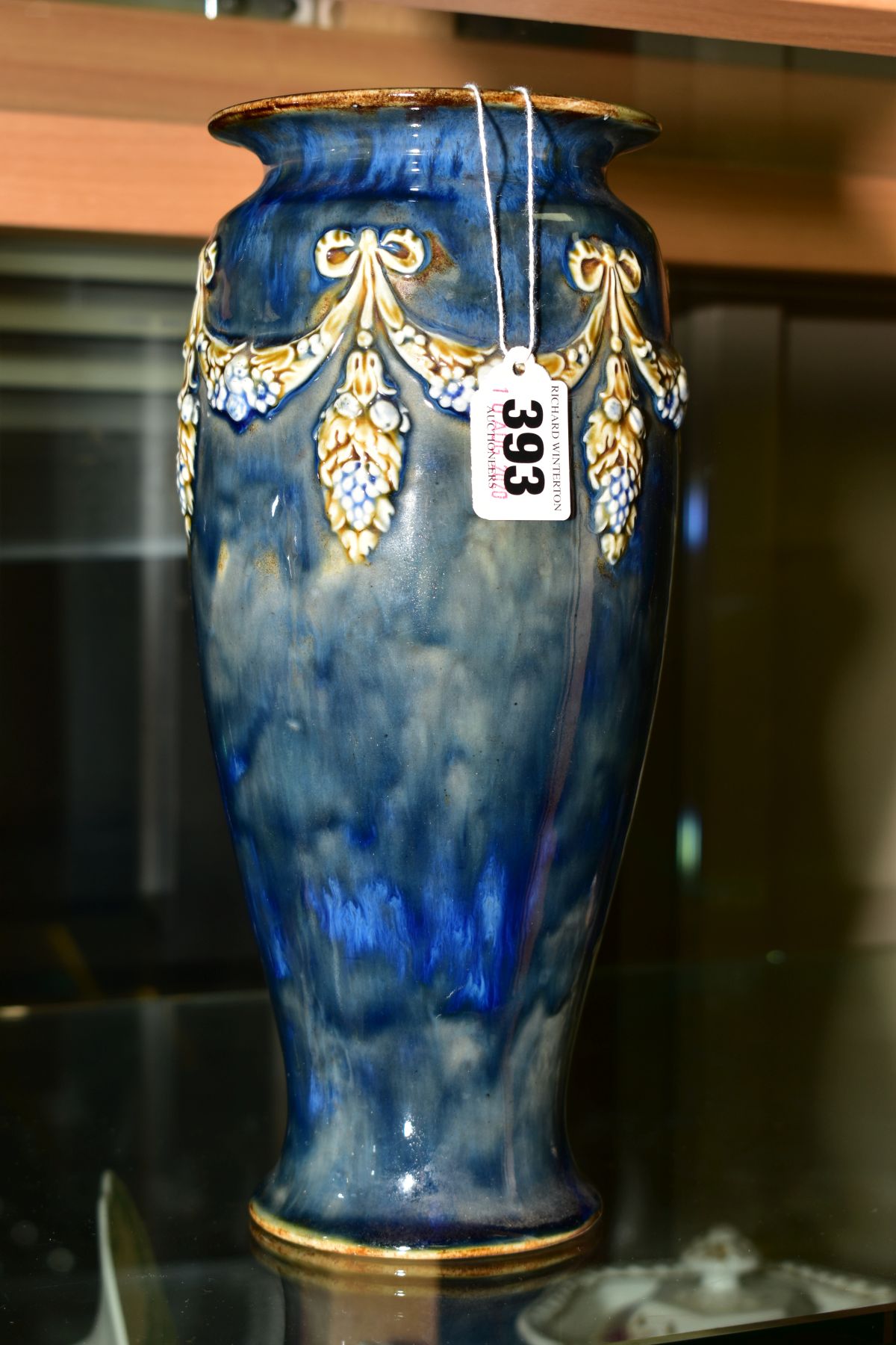 A ROYAL DOULTON VASE, approximate height 27cm, decorated around with raised swags of vine flowers