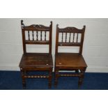 A NEAR PAIR OF EARLY 19TH CENTURY HEAVY OAK HALL CHAIRS, carved and spindled back, on turned and