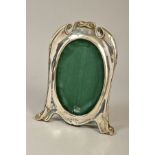 AN EDWARDIAN SILVER PHOTOGRAPH FRAME OF CARTOUCHE SHAPE, with oval aperture, easel back, maker