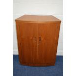A TURNIDGE 1970'S/80'S TEAK DRINKS BAR, the bow front enclosed by two full length doors with shelved