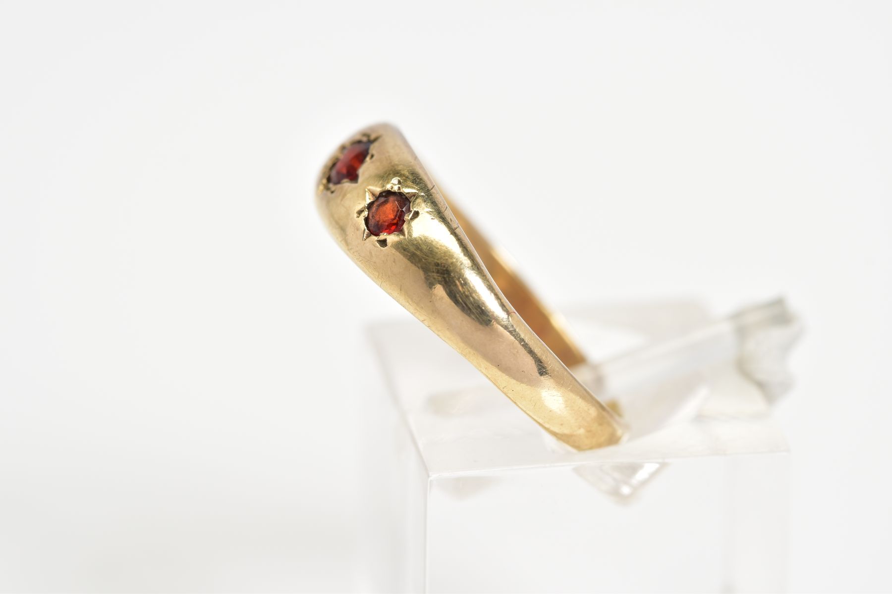 A 9CT GOLD THREE STONE RING, set with three graduated circular cut garnets within a plain polished - Image 2 of 3