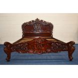 A REPRODUCTION FRENCH STYLE MAHOGANY 5' BED FRAME, with heavy carved and scrolled decoration to