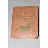 AN EARLY 20TH CENTURY POSTCARD ALBUM containing approximately seventy postcards with comic,