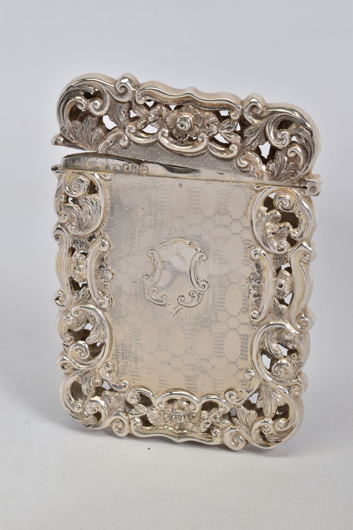 A VICTORIAN SILVER CARD CASE OF PIERCED AND WAVY RECTANGULAR FORM, engine turned decoration with