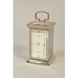 A MODERN SILVER PLATED QUARTZ BEDSIDE TIMEPIECE, of carriage clock form, hinged door opening to