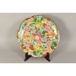 A LARGE WAVY EDGED CLOISONNE CHARGER, florally decorated, with adhesive disc hanger to base,
