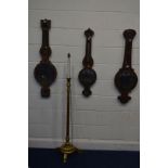 THREE VARIOUS DISTRESSED PERIOD WHEEL BAROMETERS, together with a gilt wood standard lamp (4)