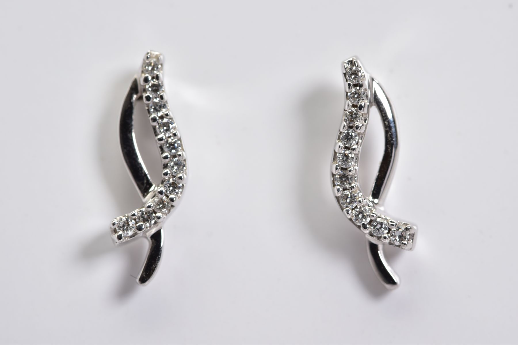 A MODERN PAIR OF DIAMOND STUD EARRINGS, estimated total modern round brilliant cut weight 0.20ct,