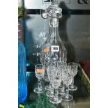 A WATERFORD CUT GLASS DECANTER, with four matching Waterford cut glass liqueur glasses, and a