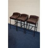 THREE MODERN BURGUNDY LEATHER BAR STOOLS, on a tubular frame (one chair missing padded feet)