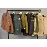 SEVEN MILITARY UNIFORM ITEMS to include Russian style tunic top and trousers, WWII style with