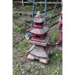 AN ORIENTAL STYLE COMPOSITE GARDEN PAGODA, in red and cream construct as five piece with three