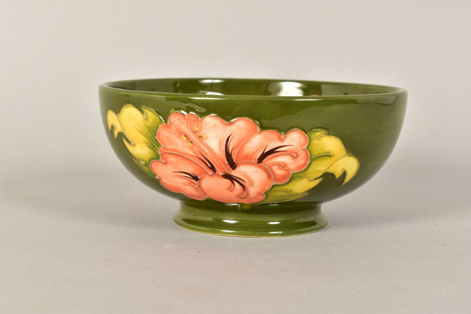 A MOORCROFT POTTERY FOOTED BOWL, 'Hibiscus' pattern on green ground, impressed backstamp and painted - Image 6 of 8