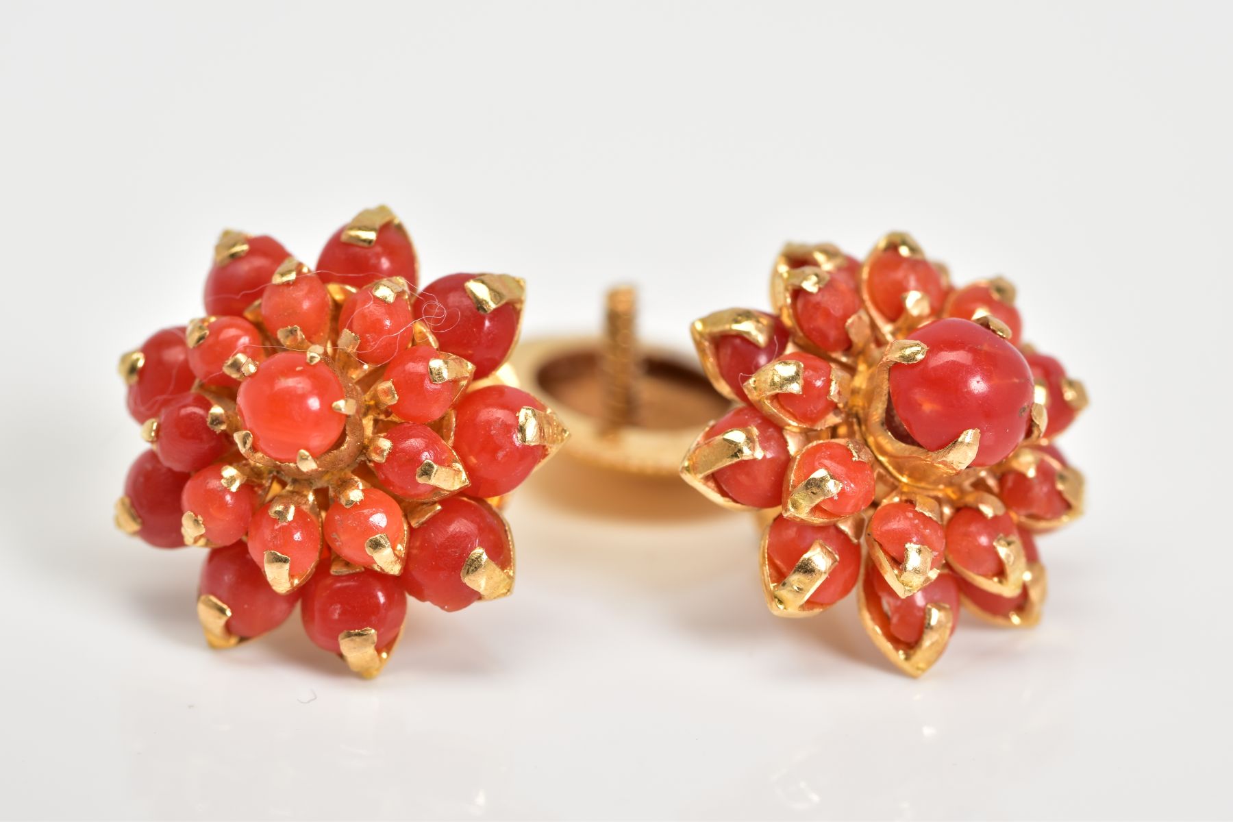 A PAIR OF CORAL EAR STUDS, a round cluster measuring approximately 16.6mm in diameter, screw post