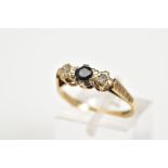 A 9CT GOLD THREE STONE RING, set with a central circular cut sapphire flanked by two single cut
