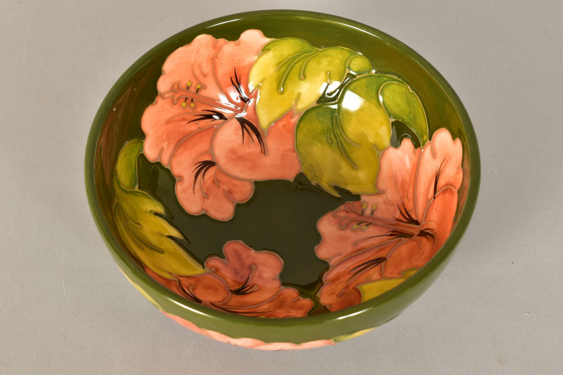 A MOORCROFT POTTERY FOOTED BOWL, 'Hibiscus' pattern on green ground, impressed backstamp and painted - Image 4 of 8