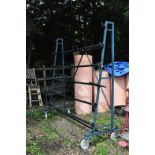 A METAL CARPET FRAME, height 222cm x width 220cm on wheels