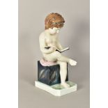 A KARL ENS PORCELAIN FIGURE, of a young child sitting reading a book, approximate height 30cm