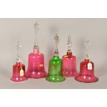 FOUR VICTORIAN CRANBERRY GLASS BELLS, approximate tallest height 32cm and a green glass bell,