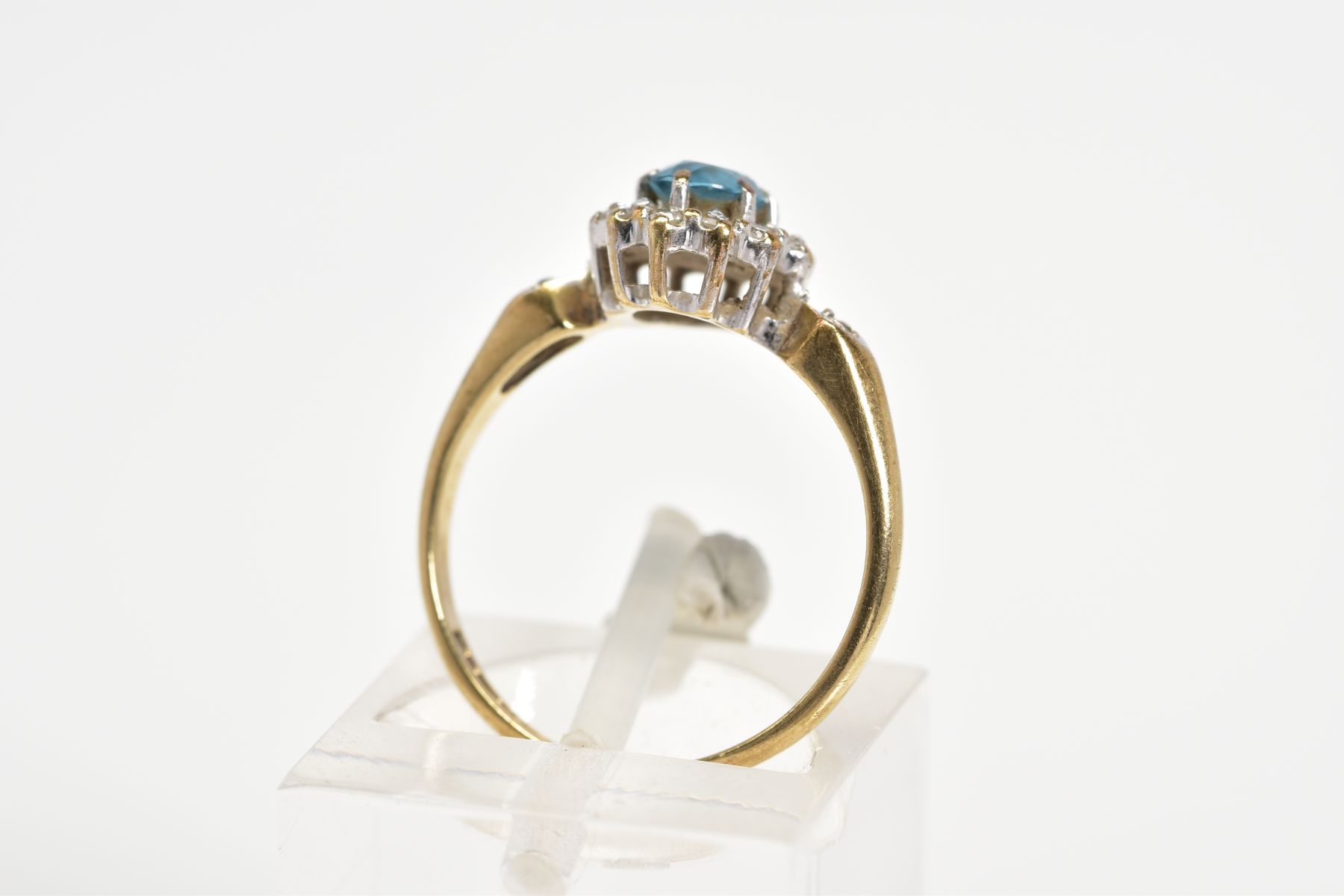 A 9CT GOLD CLUSTER RING, designed with a central oval cut blue topaz and single cut diamond surround - Image 3 of 3