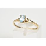 A SINGLE STONE RING, set with a central oval cut aquamarine within a four claw setting, to the plain