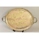 A LATE VICTORIAN SILVER PLATE TWIN HANDLED TRAY OF OVAL FORM, engraved with birds and flowers,