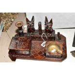 A CARVED DECORATIVE WOODEN SMOKING DESK STAND, comprising a pair of seated Scottie dogs, a candle