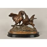 A BRONZED METAL FIGURE GROUP OF TWO COCKERELS FIGHTING, on an oval base, after A Dion, on an