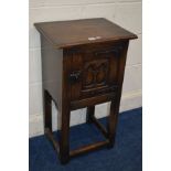 A REPRODUCTION OAK SINGLE DOOR CUPBOARD, on a stand, width 43cm x depth 35cm x height 76cm