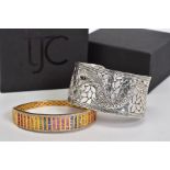 TWO BANGLES, the first a gold plated hinged bangle set with twenty two rows of princess cut