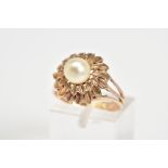 A PEARL RING, designed with a central single cultured pearl within a tiered floral surround, to