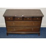 A DISTRESSED STAG MINSTREL CHEST OF SIX DRAWERS