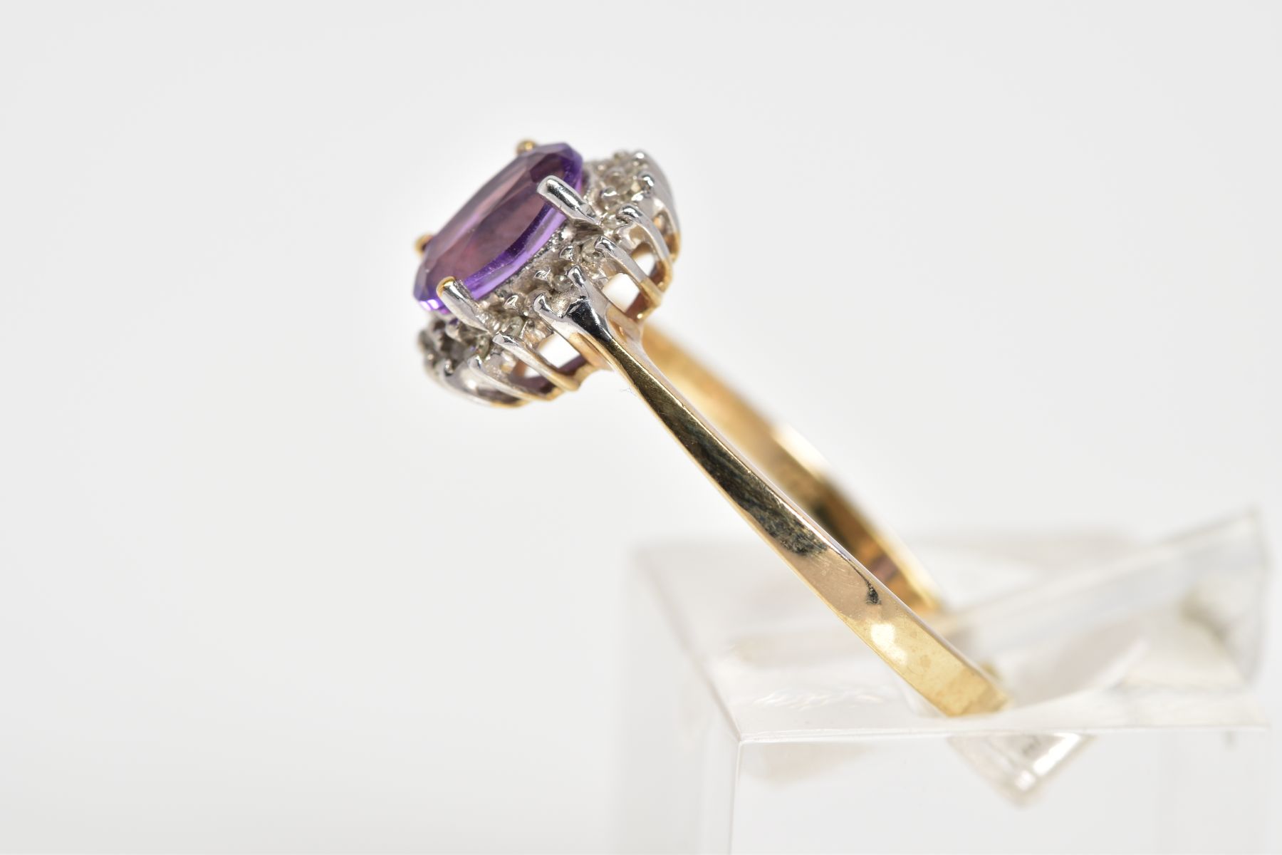 A 9CT GOLD CLUSTER RING, designed with a central oval cut amethyst and single cut diamond - Image 2 of 3