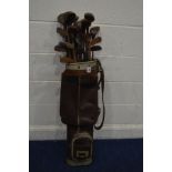 A SET OF VINTAGE WOODEN HANDLED GOLF CLUBS, including one M Mitchell and one R Simpson irons and