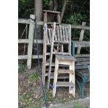 FOUR VINTAGE WOODEN STEP LADDERS, of varying ages, 77cm, 2 x 107cm and 144cm high, folded