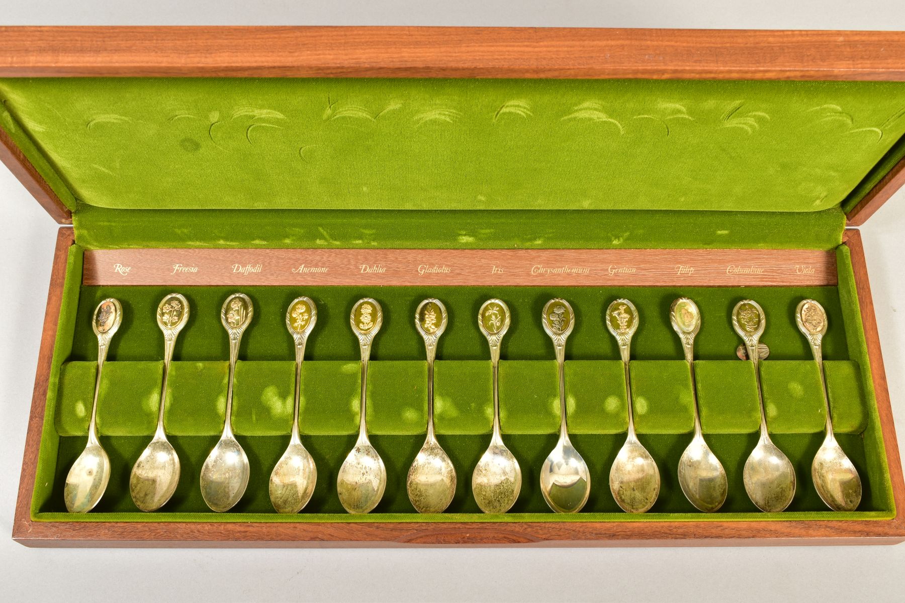 A CASED SET OF TWELVE 'THE ROYAL HORTICULTURAL SOCIETY FLOWER SPOONS', sponsor John Pinches,