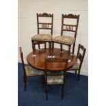 A VICTORIAN WALNUT AND MAHOGANY CIRCULAR TILT TOP BREAKFAST TABLE, on a triform base with large claw