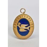 A SILVER GILT MEDALLION, of oval shape featuring a blue enamel centre with bird embellishment and