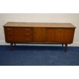 A BEAUTILITY 1960'S/1970'S TEAK SIDEBOARD, with a central fold out drinks seection, double