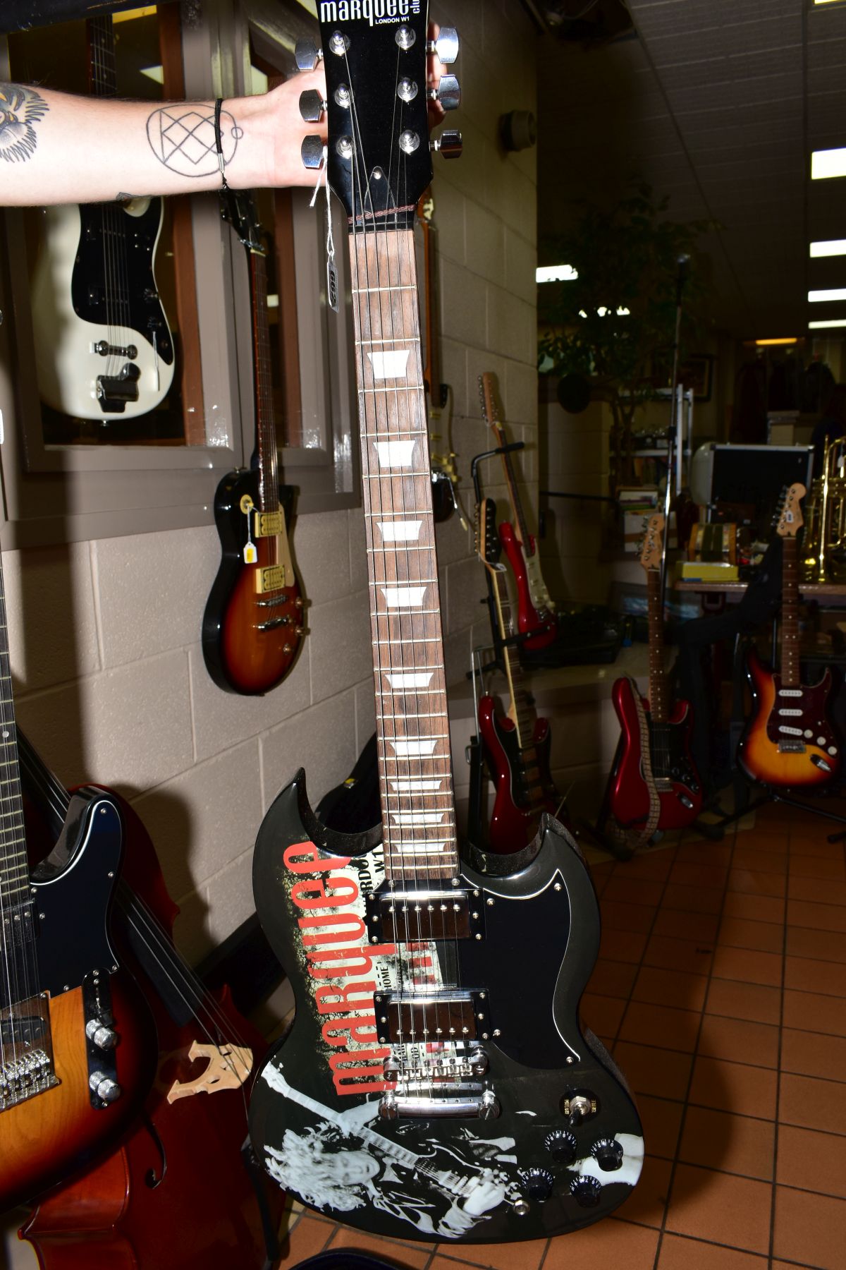 A MARQUEE CLUB 'SG' TYPE GUITAR in black with Marquee graphics to top