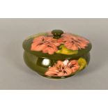 A MOORCROFT POTTERY POWDER BOWL AND COVER, green ground with coral hibiscus pattern, impressed and