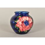 A SMALL MOORCROFT POTTERY VASE, 'Anemone' pattern on blue ground, impressed marks to base,