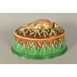 A GEORGE JONES MAJOLICA GAME PIE DISH AND COVER, the cover moulded with a game bird on applied