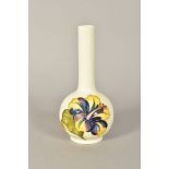 A MOORCROFT ONION SHAPED BUD VASE, cream ground with yellow and purple hibiscus flower, impressed