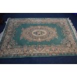 A WOOLLEN CHINESE GREEN AND CREAM GROUND CARPET SQUARE, approximately 284cm x 184cm