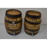 A PAIR OF VINTAGE OAK COPPERED AND WROUGHT IRON BANDED SHERRY BARRELS, marked to side, Gonzalez