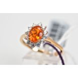 A 9CT GOLD OPAL CLUSTER RING, set with a central oval cut fire opal with a circular cut zircon