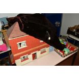A WOODEN DOLLS HOUSE, c1950's, modelled as a detached house and garage, front opening to reveal four