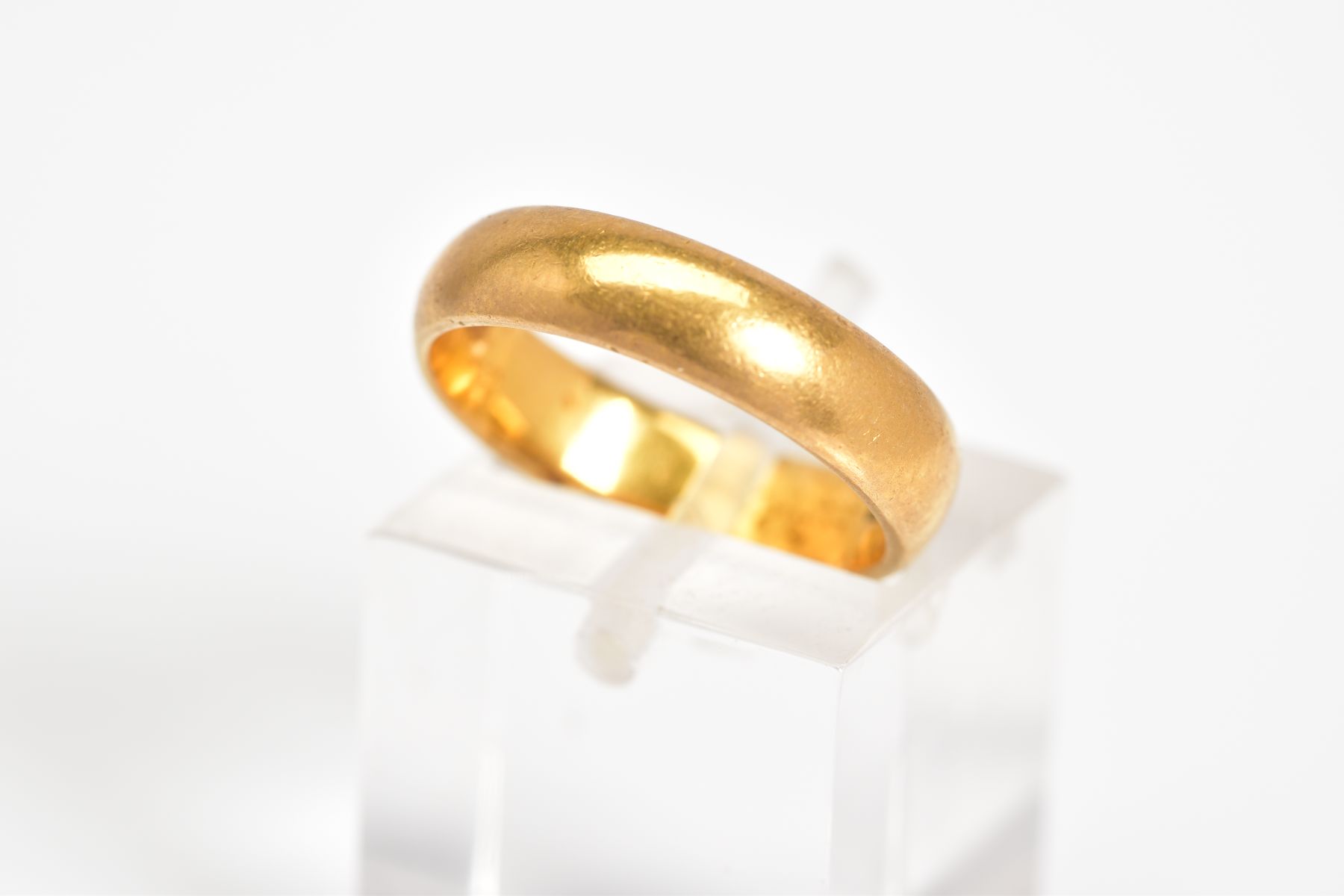 A 22CT GOLD WIDE BAND, the plain polished band with a 22ct hallmark for Birmingham, ring size K1/