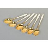 A SET OF SIX SILVER GILT AND ENAMEL TEASPOONS, the handles and back of spoons set with white shell